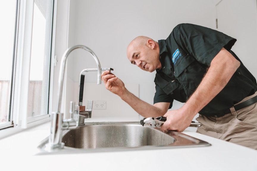 Employee Repairing Tap — Reliable Local Plumbers in Gold Coast