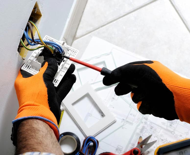 Electrician Repairing Electrical Wall Socket — Reliable Local Electricians in Helensvale, QLD