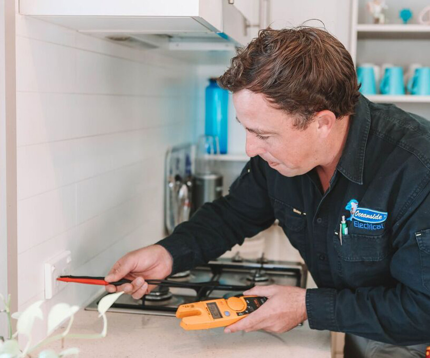 Electrician Testing a Power Socket — Reliable Local Plumbers in Gold Coast