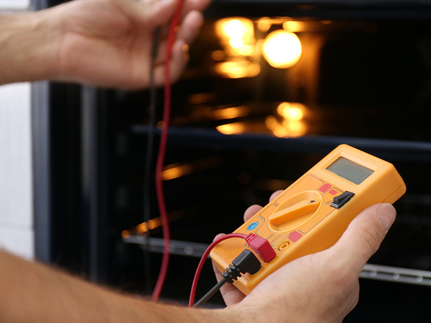 Testing Oven With a Multimeter — Reliable Local Electricians in Hope Island, QLD