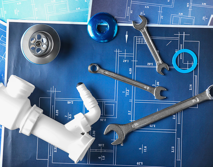 Plumbing Equipment on top of Technical Drawings — Reliable Local Plumbers in Runaway Bay, QLD