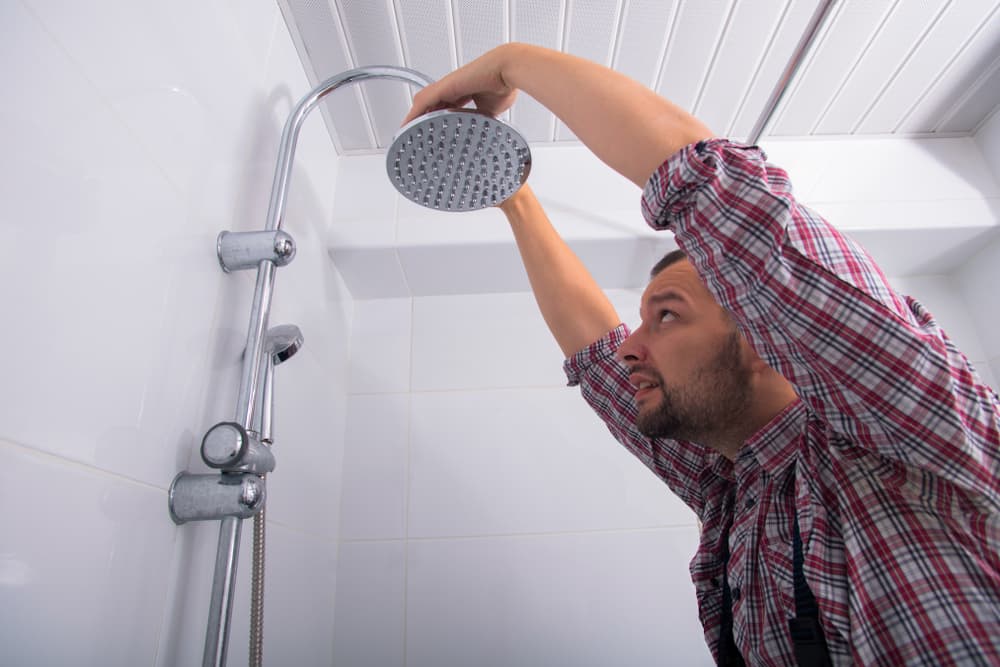 Shower head being fixed — Reliable Local Electricians in Helensvale, QLD