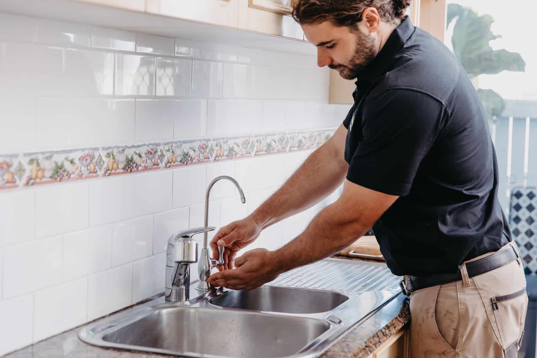 Plumber checking the tap