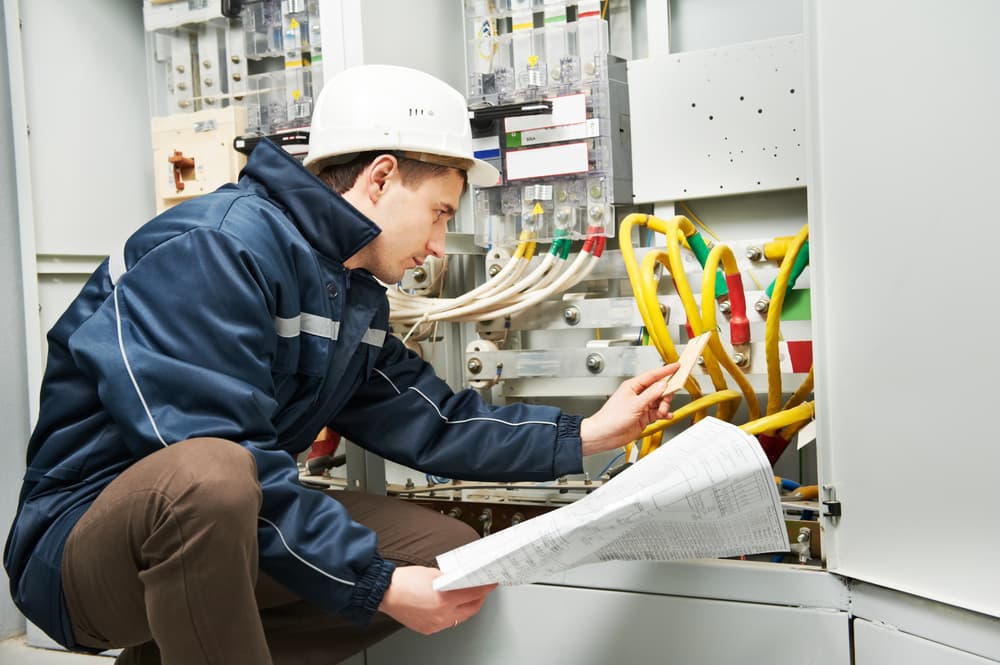 Electrician checking electrical cables — Reliable Local Electricians in Helensvale, QLD