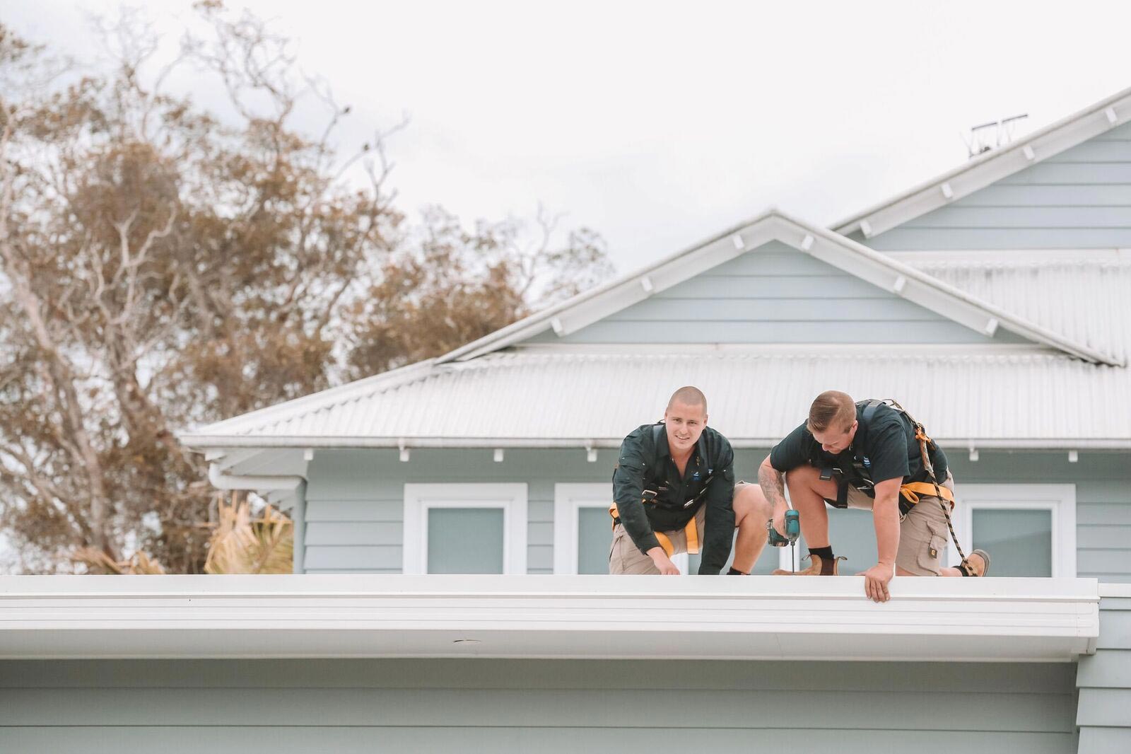 Two Men Repair Roof