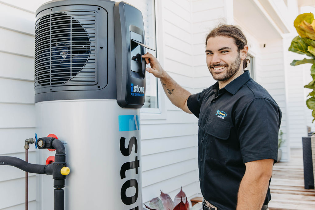 plumber fixing hot water system