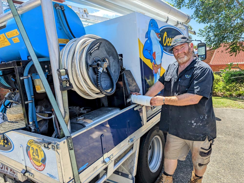 Plumber Standing Next to A Vehicle