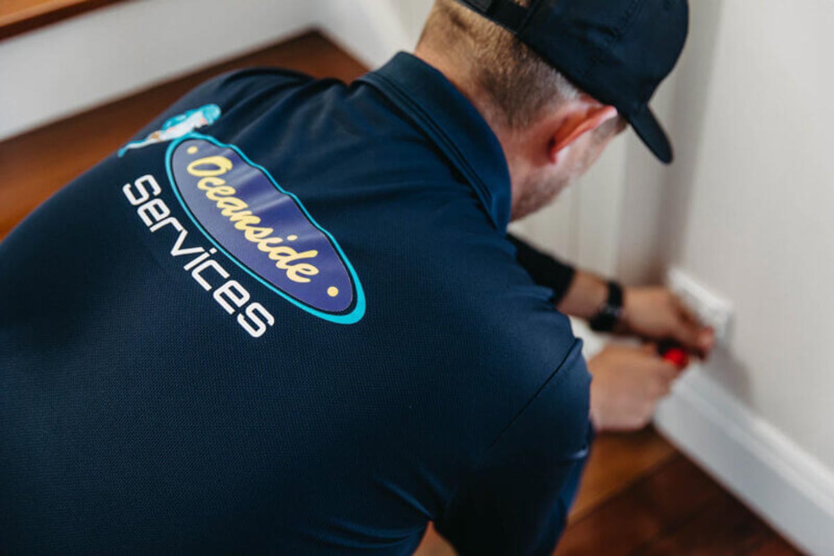 Electrician On The Gold Coast Installing Outlet